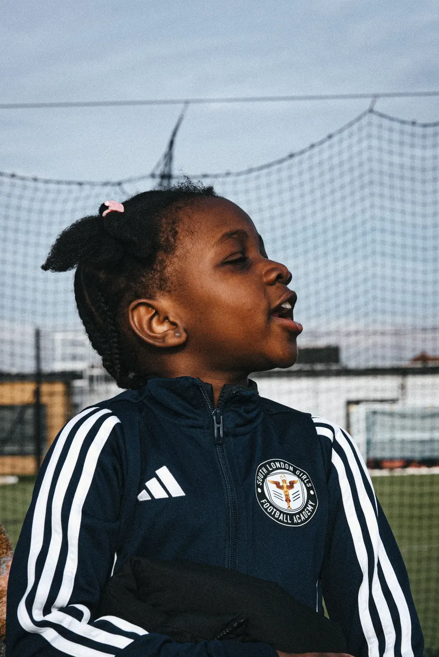 A player watching the game from the sideline