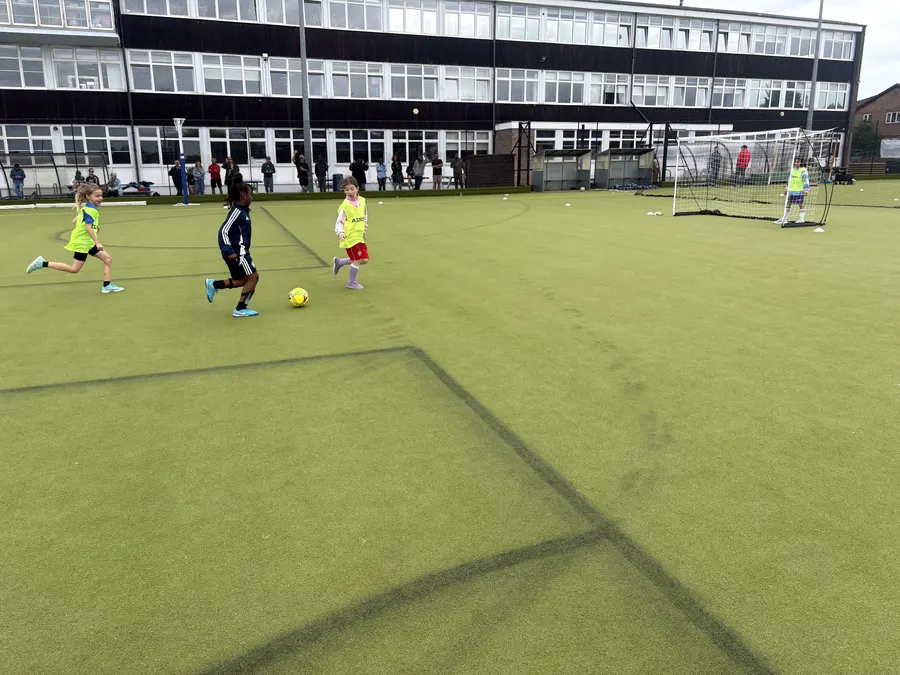 Girls chasing the ball in a small-sided game