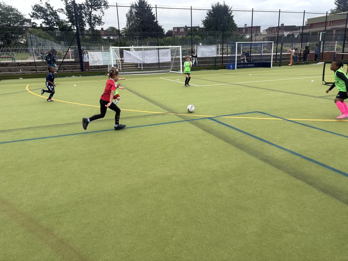 Under 8 girls in a 5v5 match with goalkeepers